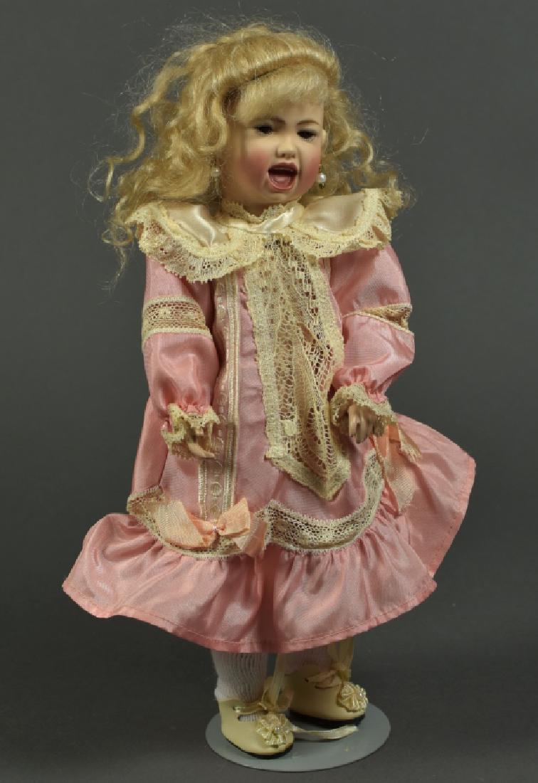 French Reproduction Jumeau Screamer: 11". Brown glass eyes, pierced ears, mohair wig. Composition Seeley body. Silk and cotton lace dress.
