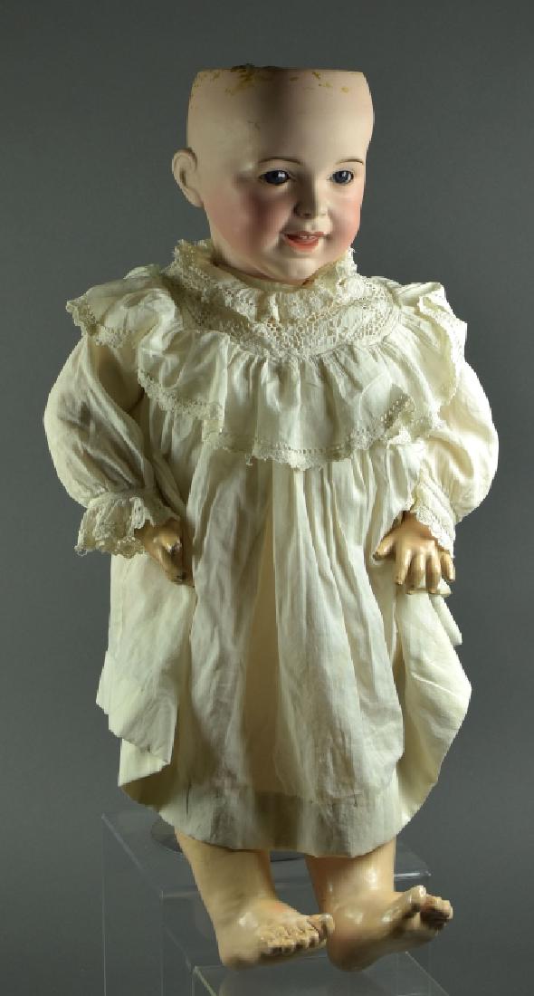 French SFBJ Laughing Jumeau Toddler: 26". Blue sleep eyes, open close mouth with two teeth. Synthetic wig. Has piece broken out across top of head, hairline into right eyesocket, eye chip repair left corner eye. Composition jointed toddl