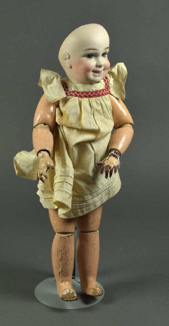 Reproduction French Jumeau Character Series: 17". Open close mouth with teeth, pierced ears, blue set eyes, French antique body, human hair wig. Body has heavy paint loss.