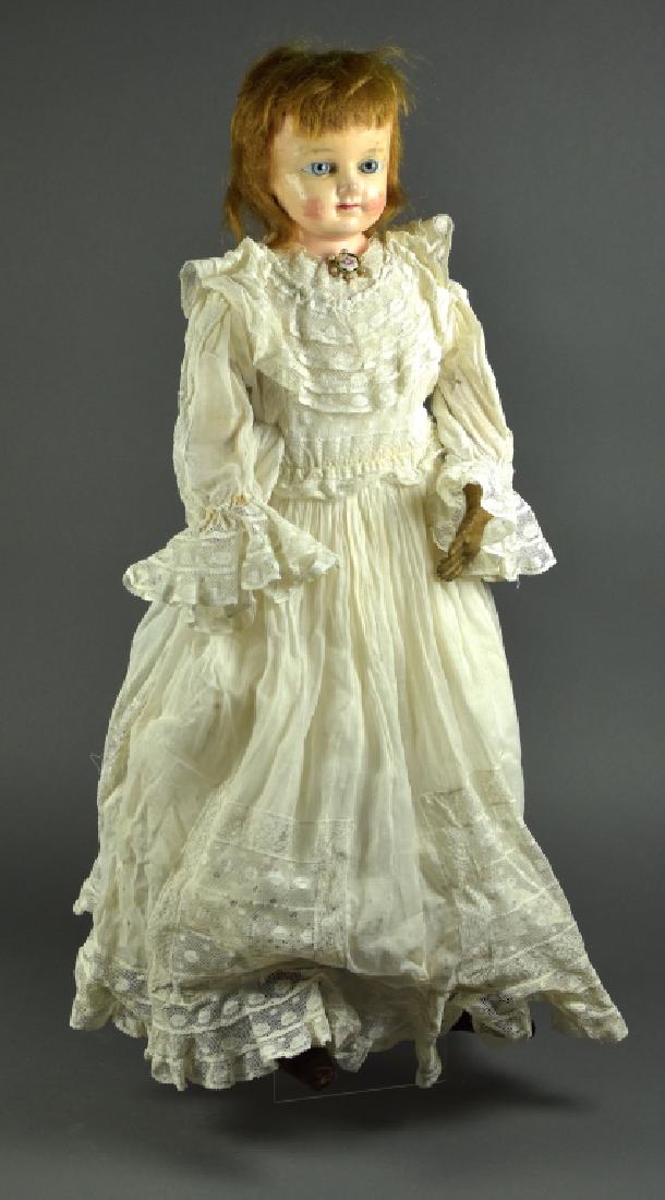 Wax Over Composition Shoulderhead Doll: 26". Blue set paperweight eyes, mohair wig, cloth body with leather arms, ( one hand gone ). Body is newer. Some cracks on forehead and cheeks have repaint. Antique clothing.