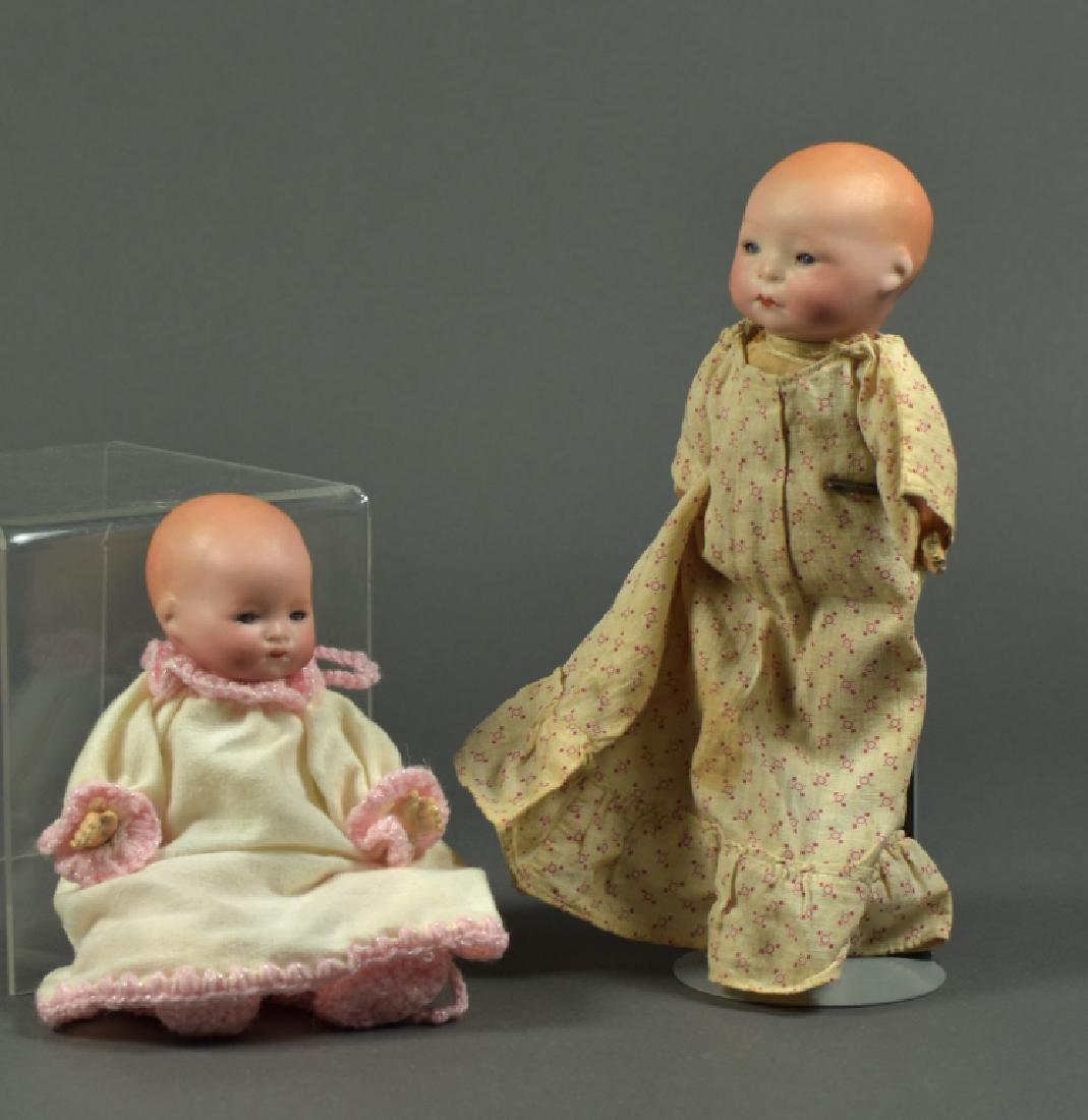 German Armand Marseille 341 Infant Doll: 7". Blue sleep eyes, closed mouth, dome head with painted hair. Five piece composition baby body. Newer clothing. Also an 8" Amberg & Son flange head body. Blue set eyes, closed mouth, dome head with 