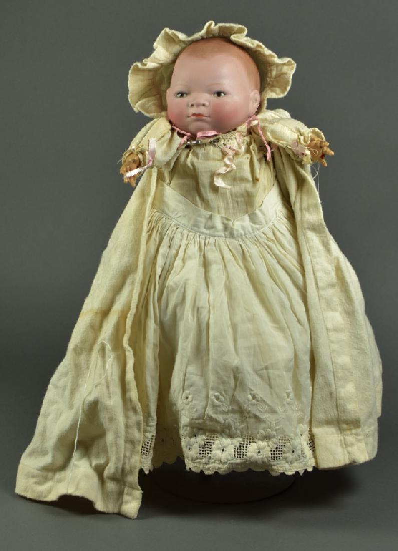 German Grace S. Putnam Bye-Lo Baby: 15". 12" head circumference. Rare brown sleep eyes, painted dome head and hair. Flange neck on original cloth body. Celluloid hands, left hand has finger missing, Wonderful paint and coloring. Antique