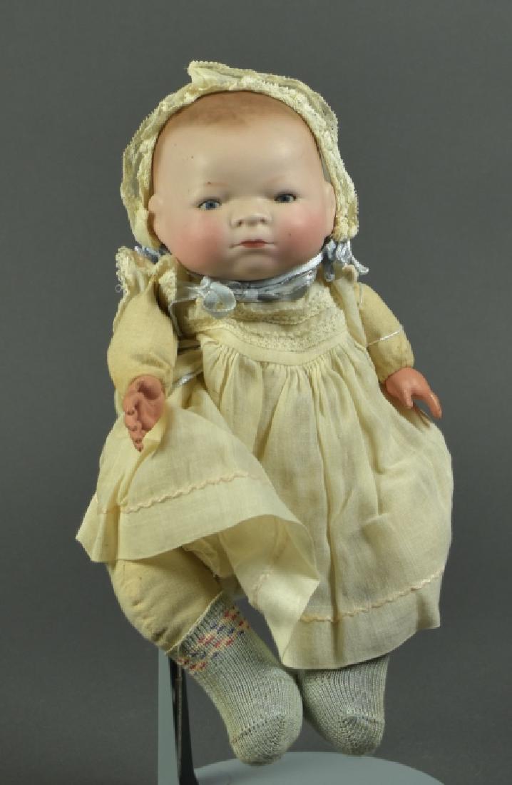 German Grace S. Putnam Bye-Lo Baby: 12". Blue sleep eyes, closed mouth. Flanged neck on cloth stuffed body with crier ( does not work ). Dressed in antique cotton dress; hat.