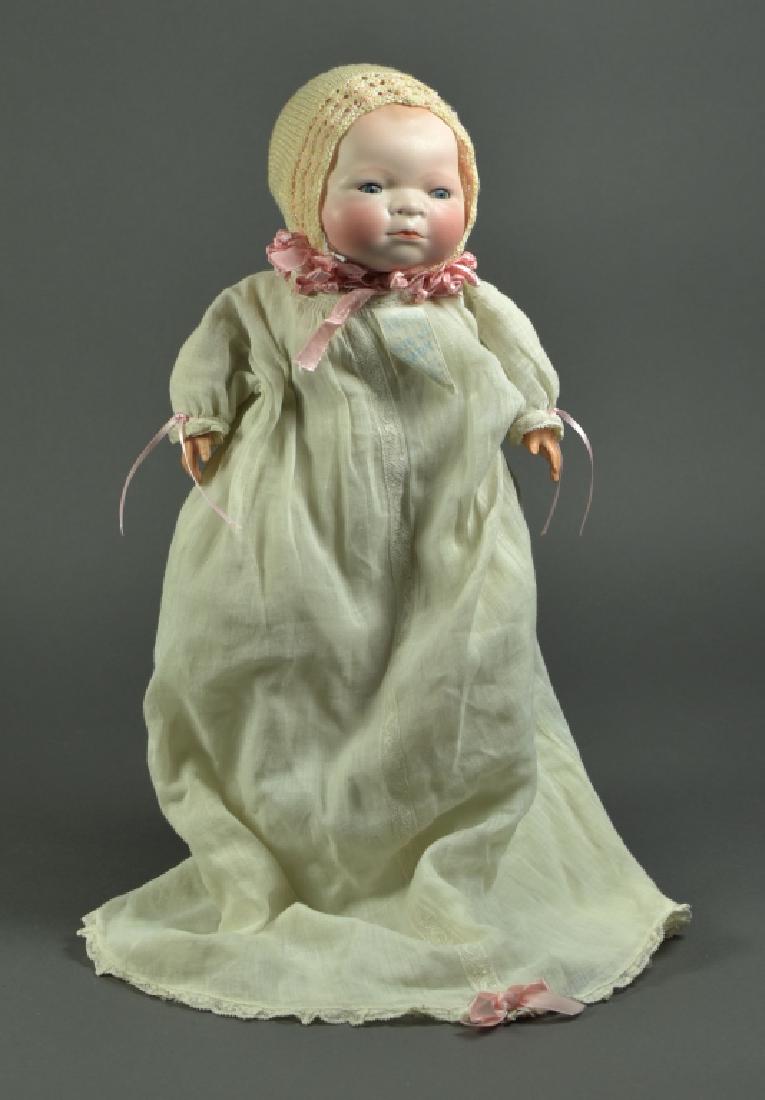 German Grace S. Putnam Bye-Lo Baby: 15". Blue sleep eyes, painted dome head and hair. Celluloid hands, cloth stuffed body with non working crier. Dressed in antique clothing. Original tag.