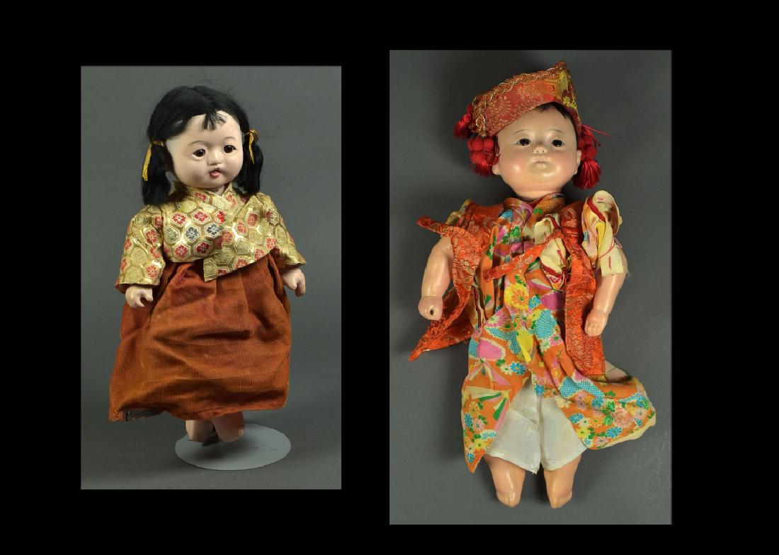 Pair of Japanese Oriental Composition Dolls: 13" and 15". Brown set eyes, black mohair wigs, papier mache bodies. One has open close mouth, second has closed mouth. Nice oriental clothing. Very good condition but needs restringing.