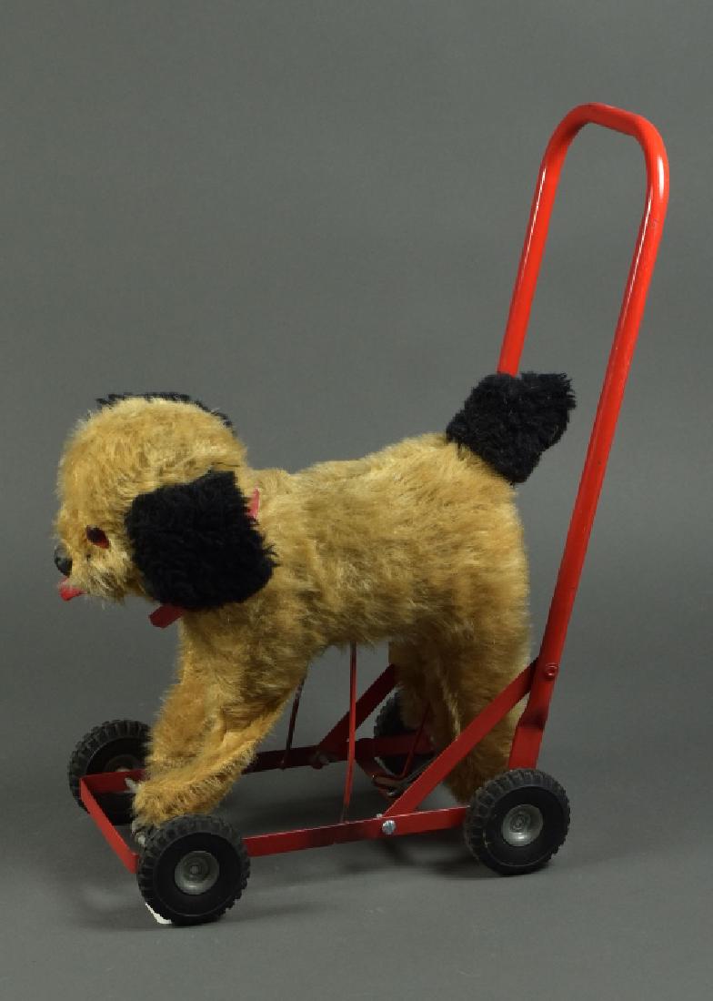 Irish Mohair Dog on Pull Wheels: 12". Button eyes, red enamel frame. With original label underneath.