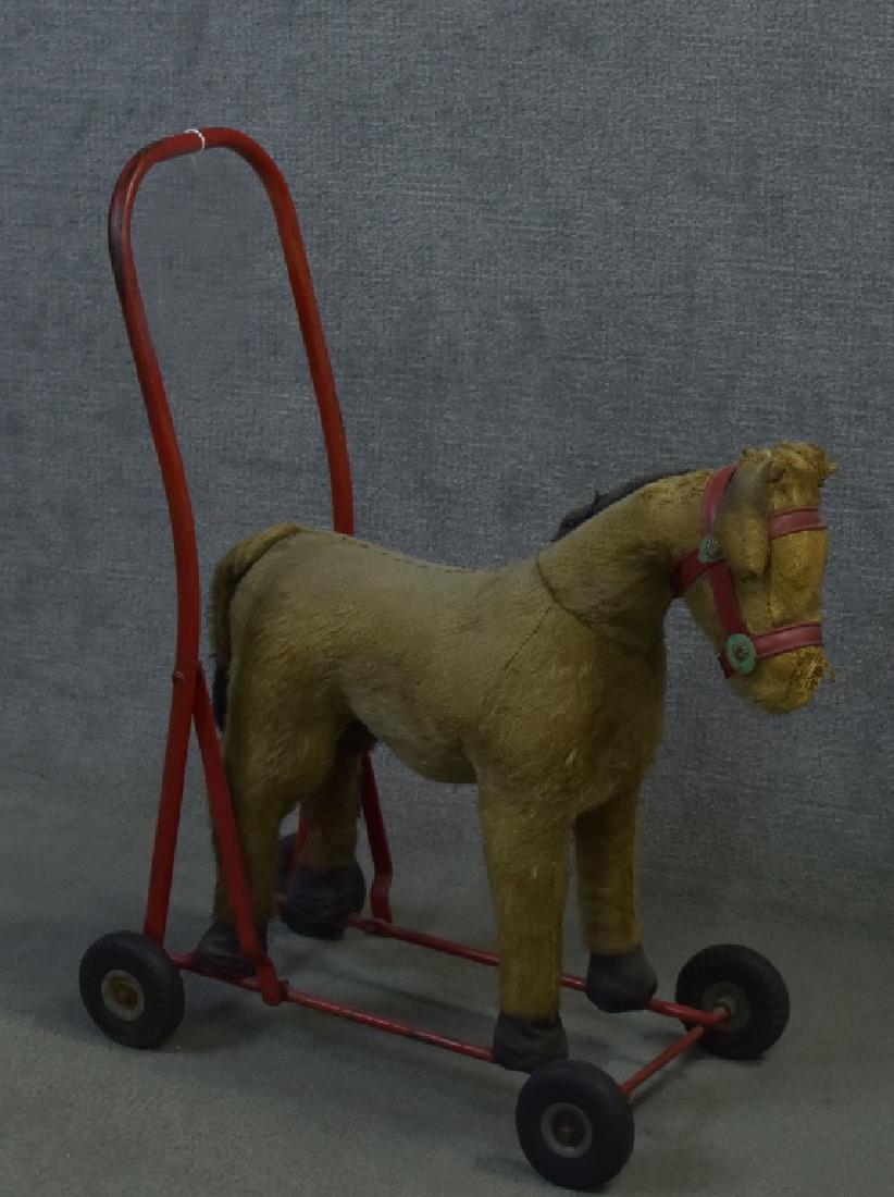 Mohair Rolling Horse: 21"H. Glass eyes. Original cloth label "Made in Ireland", Lines Bros.,Ireland Ltd. Mild steel frame, rubber tires, body stuffed with wood wool, body covered 26% mohair, 23% fiber, 51% cotton. Wear to 