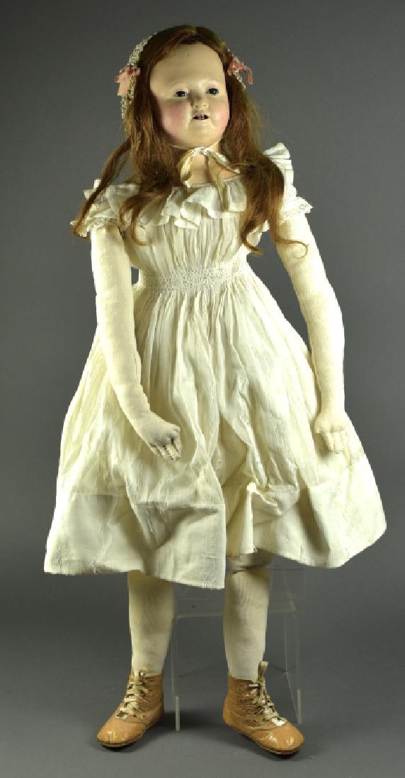 Papier Mache French Type Shoulderhead: 33". With molded ears, repainted head. Glass eyes. Replaced body, antique clothing.