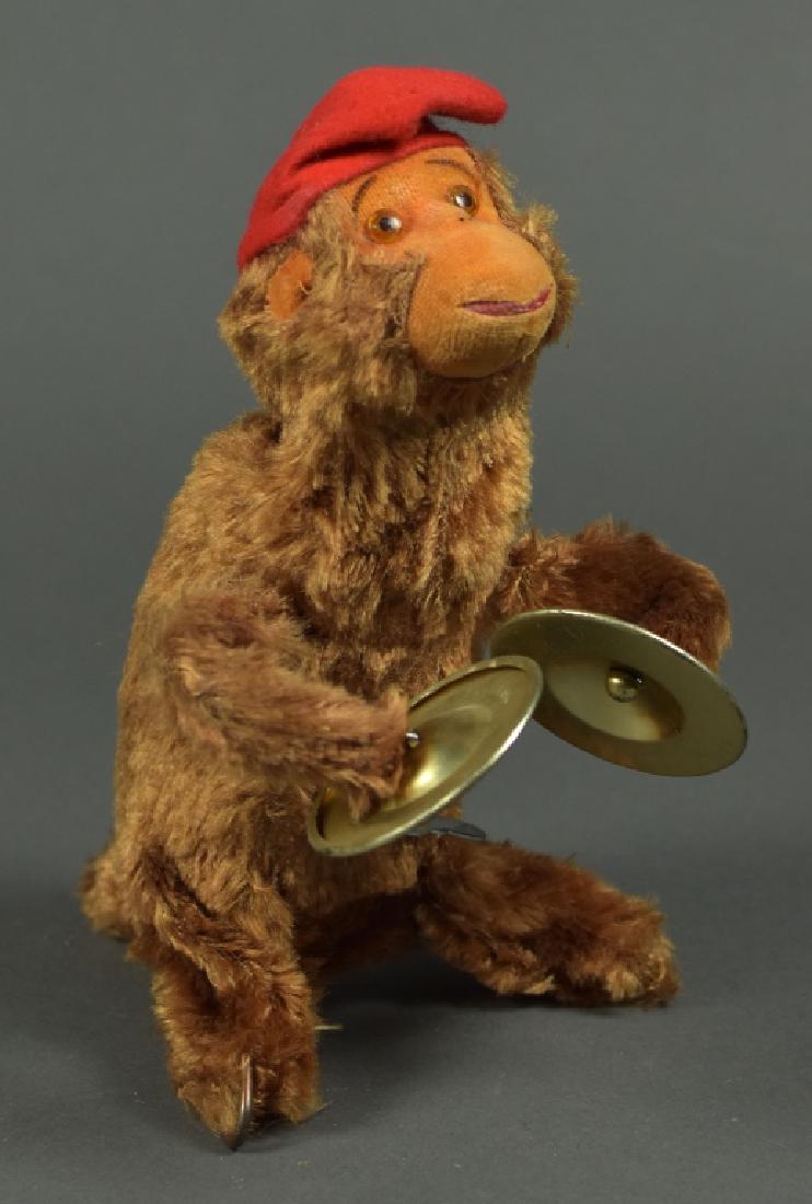 Wind Up Monkey with Key: Moves with help.