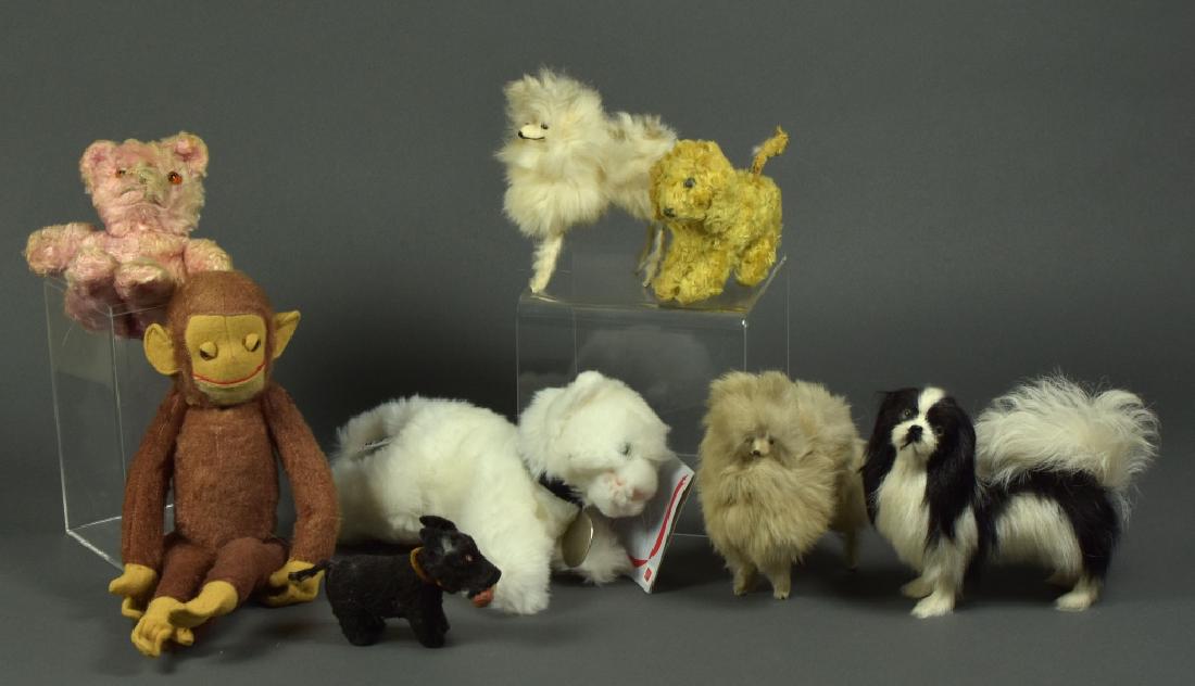 Three Fur Dogs and More: Along with two wind up dogs in unknown working condition ( no keys ), plush pink bear, jointed monkey and modern plush cat.