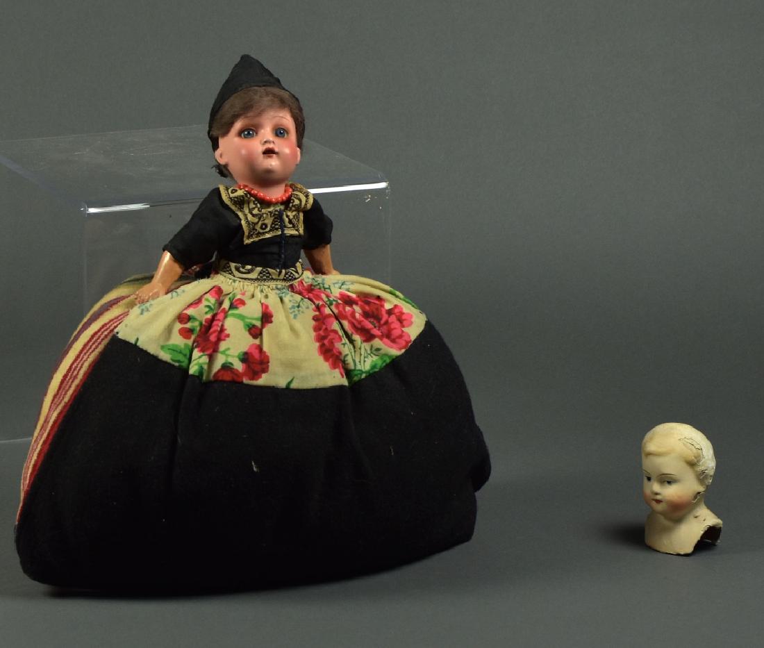 Two Dolls: 11" French bisque head with composition arms. Teapot cover, blue glass eyes. Papier mache shoulderhead.