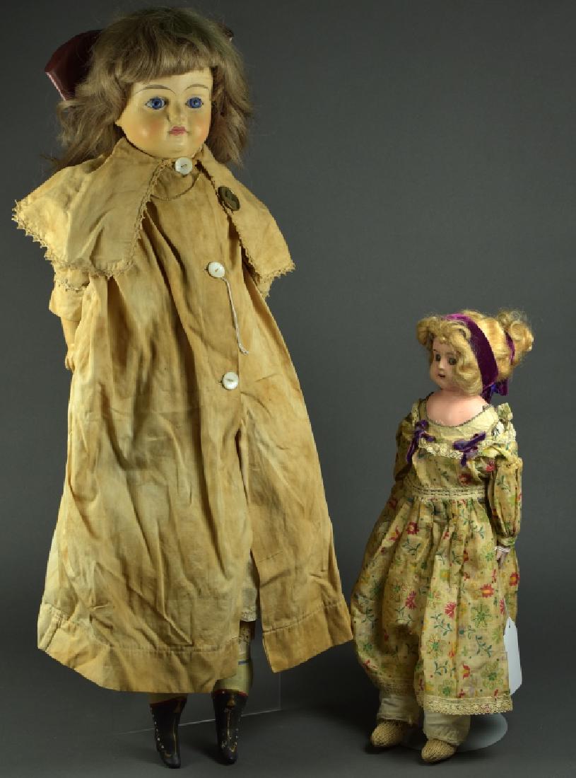 Two Papier Mache Dolls: 30" papier mache doll with glass sleep eyes, cloth body, composition lower arms, original high heeled boots, wearing antique child's photo pin, replaced wig. 20" papier mache doll with kid skin body,
