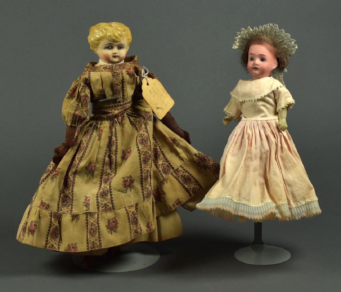 Two Dolls: 9" German bisque head doll on composition body, open mouth with teeth, blue glass eyes, original mohair wig, vintage clothing. 12.5" glass eyed papier mache doll on original cloth body with leather lo