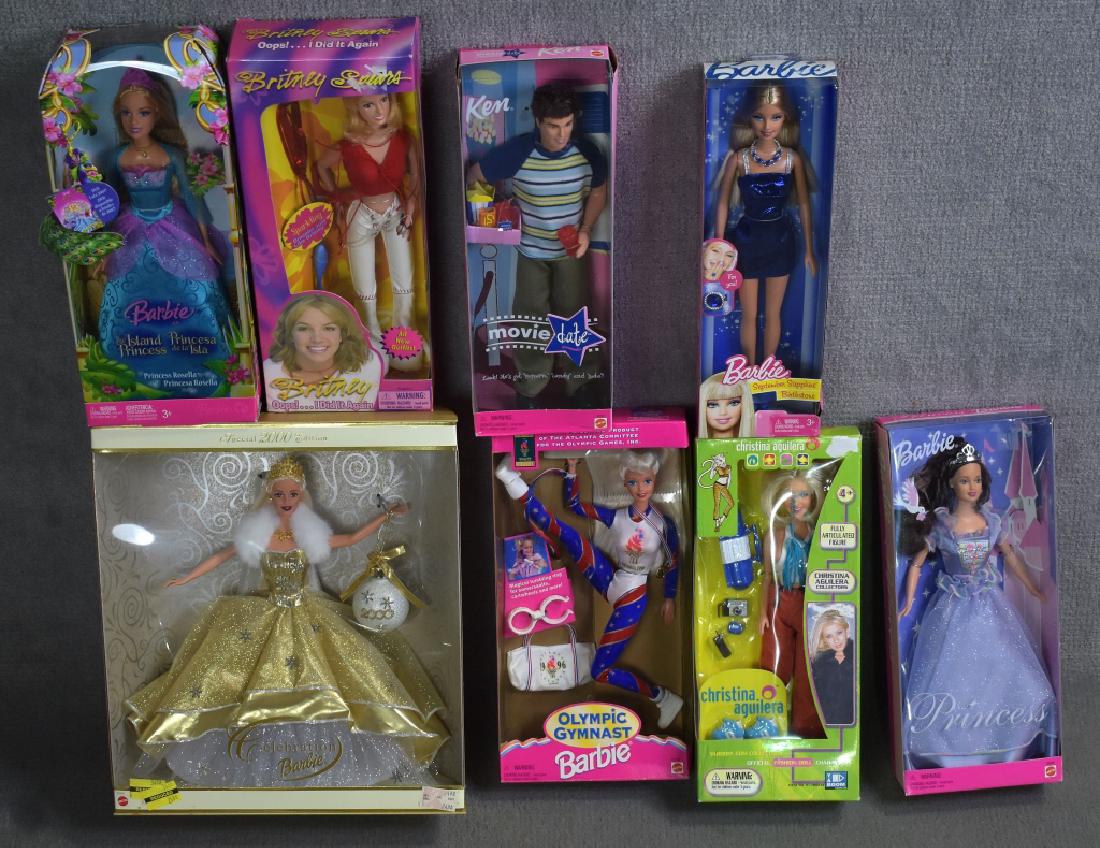 Group of Barbies and Collector Dolls: Includes a Britney Spears doll, Christina Aguilara doll, 2000 Celebration Barbie, Olympic Gymnast Barbie, Movie DAte Ken, and more. Good condition with pen writing and torn off sticker areas. Eight do