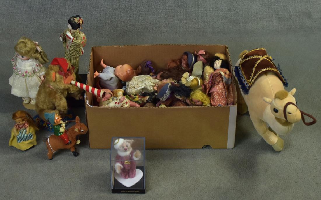 Variety of Vintage Dolls and Toys: Includes wind up plastic crawler babies, stuffed camel, Japanese figures, tin litho battery operated monkey with striped horn, working condition unknown. Fair condition overall.