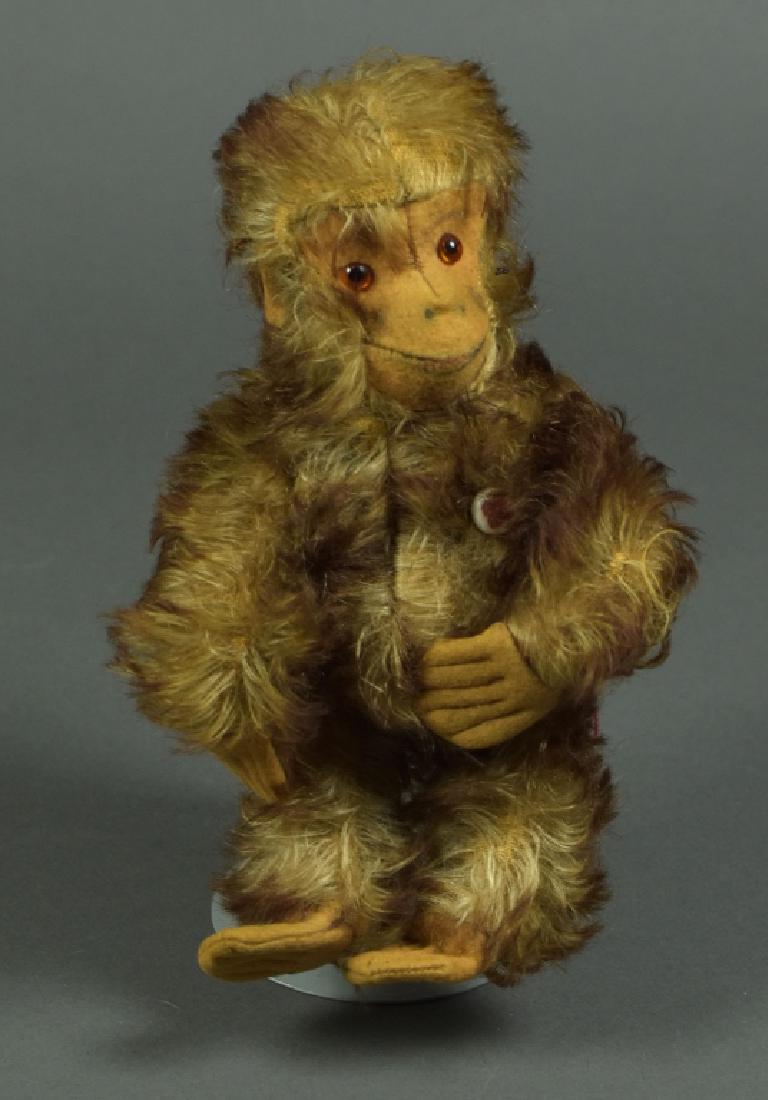 Vintage German Petz Mohair Monkey: 8". Spots of lost mohair, some staining on face and signs of insect habitation. Overall still sturdy. Bears the Petz button on his chest,