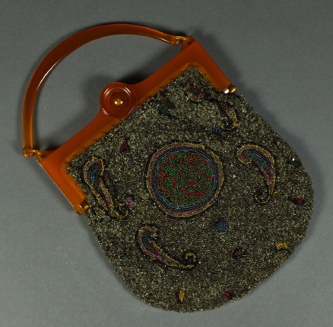 Paisley Design Seed Bead Handbag Lined in colorful: Lined in colorful patterned silk. There a few loose threads and missing beads but overall in good condition. Plastic frame, possibly apple juice bakelite. 7"W.