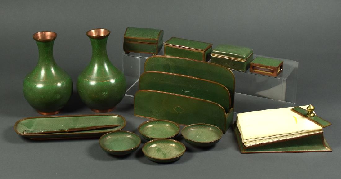 Green Enamel on Copper Cloisonne Desk Set Intricate: Intricate design on each piece. Includes letter holder, stamp box, pair of vases, letter opener, matchbox holder, and more. All in good condition with the exception of the vases which have dented dama