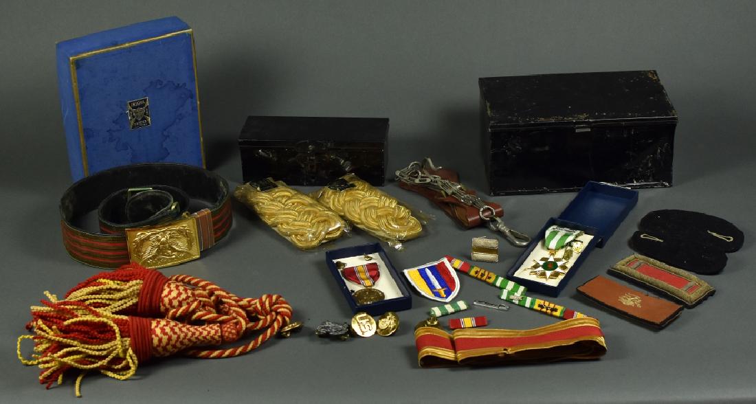 Group of Uniform Items and Insignia Group of uniform: Group of uniform items including new in the box Coastal Artillery officers belt by NS Meyer. General epaulettes in original tin box. Sword hanger. Vietnam medal in box and misc insignia. Most show lig