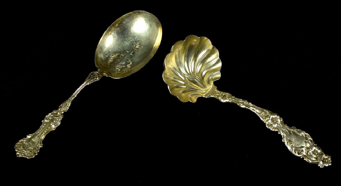 Sterling Silver Ladle and Spoon A Whiting "Lily" gravy: A Whiting "Lily" gravy ladle, 1902. Marked for Shaw and Barry, retailers in Washington D.C. Along with a patented 1898 serving spoon, monogrammed. Good with wear and tarnishing. Spoon is 7 1/2 inches 