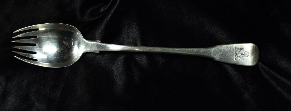 Thomas Wilkes Barker Silver Serving Spoon Spork: London silversmiths. 11.5 inches long. Handle is etched with classical nude motif. Good with minor wear. We believe this was originally a complete spoon that was later converted to a spork. 11.5 inche