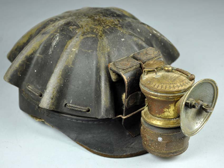 Early Miner's Hard Hat with Autolite Carbide Lamp: Early Miner's Hard Hat with Autolite Carbide Lamp Heavy wear to top and sides. Leather is solid. Liner is intact.