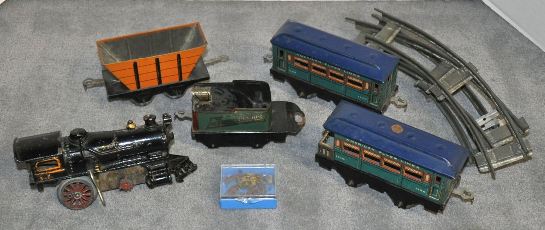 Tin Wind-Up American Flyer Train: Tin Wind-Up American Flyer Train Engine and three cars along with a Marx hopper. Cast wheels on engine are broken. Engine runs.