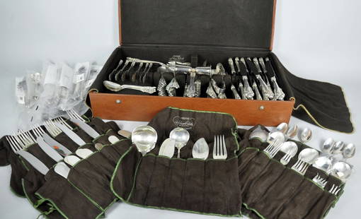 Set of Sterling Flatware by Wallace: "Grande Baroque" (1973). Including: 8 8" dinner forks, 14 7 1/2" luncheon forks, 7 pickle forks, 5 olive forks, 8 steak knives, 24 cream soup spoons, 1 jigger, 1 pair slotted ice tongs, 17 flat handle