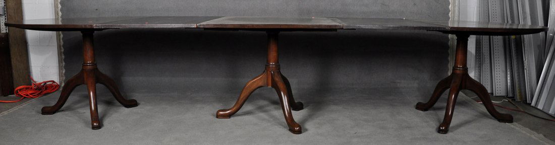 Kittinger Colonial Williamsburg Banquet Table: 20th century. Mahogany. Three pedestal construction with two 33" Dia. ends, a 32" center, and two 24" leaves. 28 1/2" x 48" x 146" fully extended.