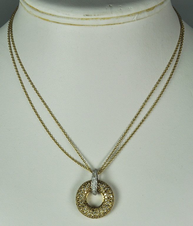 Roberto Coin Brown and White Diamond Necklace: 18K yellow and white gold. Pendant contains 1.85 carats of brown diamonds, and .24 carats of white diamonds. Suspended on two 18K Roberto Coin 16" and .85mm wide each rolo chain. One diamond missing f