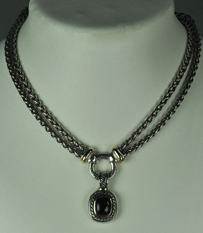 David Yurman Black Onyx Pendant Necklace: Sterling and 14K black onyx enhancer on 18K sterling two row wheat chain with center donut. Each chain is 3.5mm wide and 16" long. Weighs 64.9 grams.