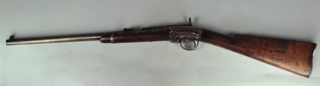 Smith Carbine: Ser# 20799. All grey gun with partial inspector cartouche on stock. Forearm is damaged and has replacement screw. Front sight is modified. Saddle ring is present. Barrel, 21 5/8", 39" overall.
