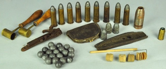 Two Powder Measurers: Along with shotgun, lead balls, and nine approximately .50 caliber 19th century center fire shells each 2 3/'8" L. Wear and rust, heavy patina to brass.