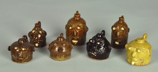 Seven King's Pottery Miniature Face Jugs (N.C.): From King's Pottery of Seagrove, N.C. All signed "King's Pottery/Anna King" some dated 1992. 1 1/4" - 2" H. From the collection of Howard and Anne Smith of Mayodan, North Carolina.