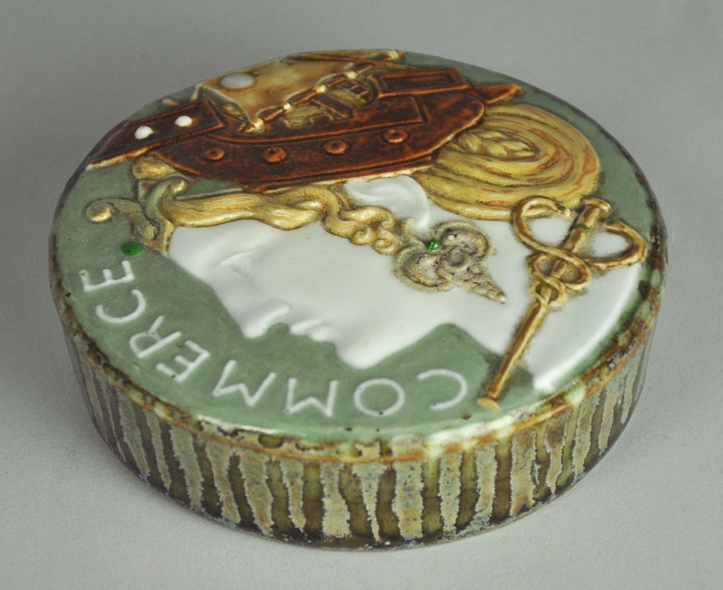 Sevres Porcelain Paperweight: "Commerce," pate sur pate decoration. Designed and decorated by T.M. Doat, Paris, 1901. Marked, "Doat/1901/Sevres." Excellent condition. 4 1/8" Dia.
