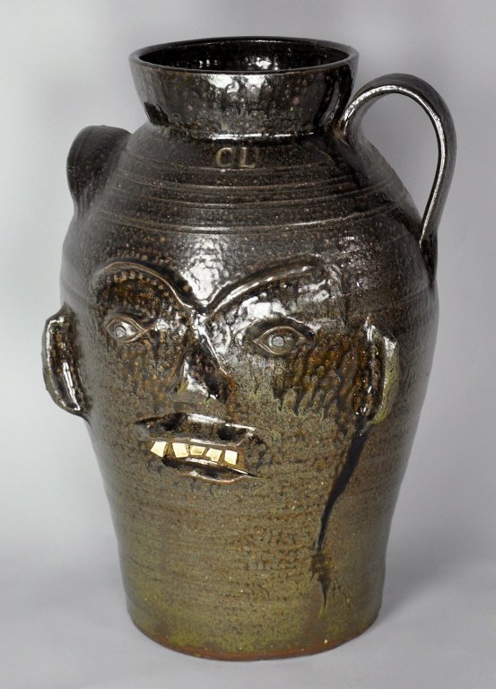North Carolina Alkaline Glaze Face Crock: With porcelain teeth. Stamped, "C.L." (for Charles Lisk) on front. Good condition. 15 1/2" H. From the collection of Howard and Anne Smith of Mayodan, North Carolina.