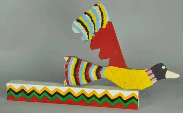 Folk Art Flying Bird by Willie Massey: American - Kentucky, 1906-1990. Massey was a sharecropper most of his life, but began making folk art after the death of his wife in 1955. Wooden base and bird with metal wings. Good condition. 12" x 
