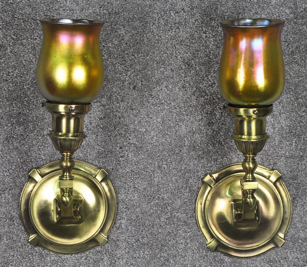 Pair of Vintage Cast Brass Wall Sconces: With iridescent Gold Aurene style shades. Manufactured in New York by the Sterling Bronze Company and is so marked on a plate affixed to their sconce. The Sterling Bronze Company was a premier manufac