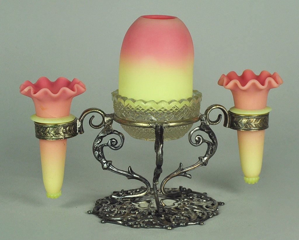 Burmese Epergne with Fairy Lamp: By Thomas Webb & Sons, 1885-1925. Center fairly lamp is flanked by two matching Burmese posy holders. Fairy lamp rests in clear glass insert marked,"S. Clarke Fairy Pyramid." Entire ensemble sits on m