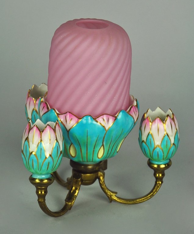 Porcelain Fairy Lamp with Pink Satin Glass Shade: Pink shade in swirl pattern. Three porcelain tulip buds in pink and teal surround the matching centerpiece fitted with a pottery insert produced by Taylor, Tunnicliff & Co. During the late 1880's S. C