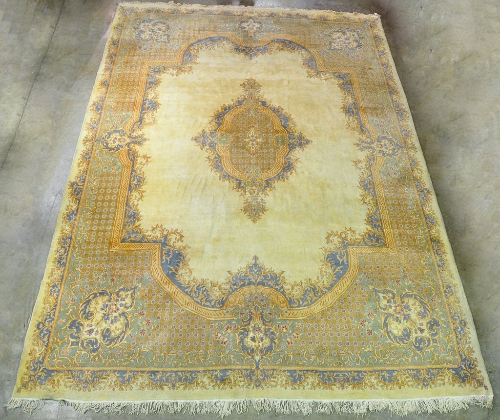 Wool on Cotton Irani Oriental Rug: 20th century. In French Aubusson design. Beige and blue center medallion on ivory ground with matching floral and fleur-de-lis border. 215" x 139 1/2".