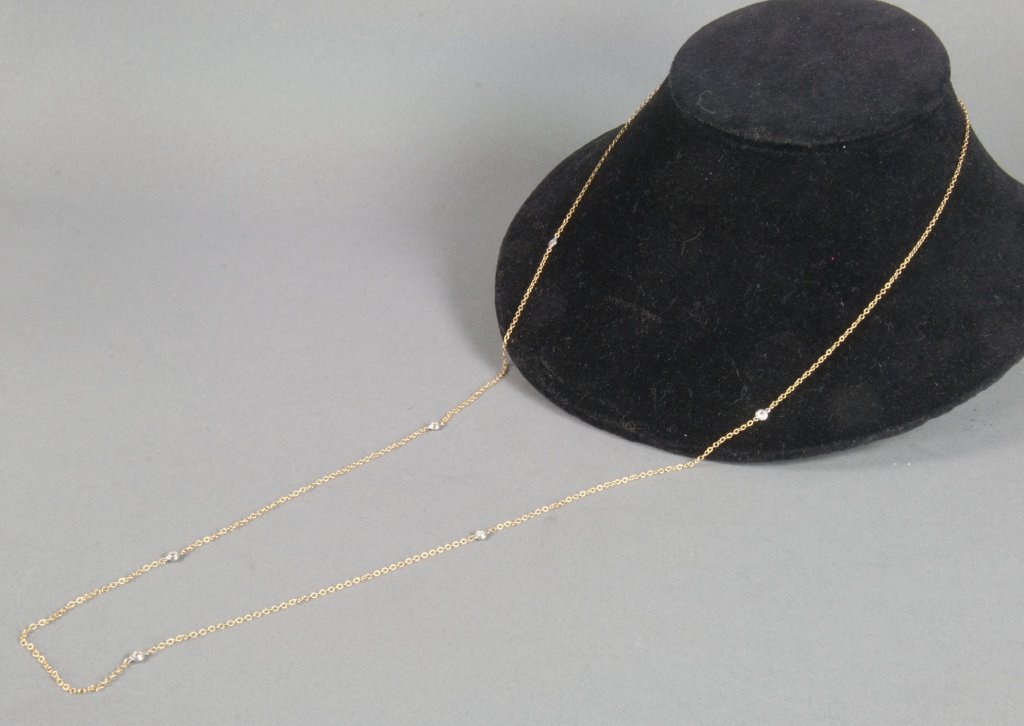 Elsa Peretti Tiffany & Co. Necklace: "Diamonds by The Yard" necklace with six diamonds, approximately 0.1 ct each. 0.6 ct total weight. 36" long, 18K gold. Excellent condition.