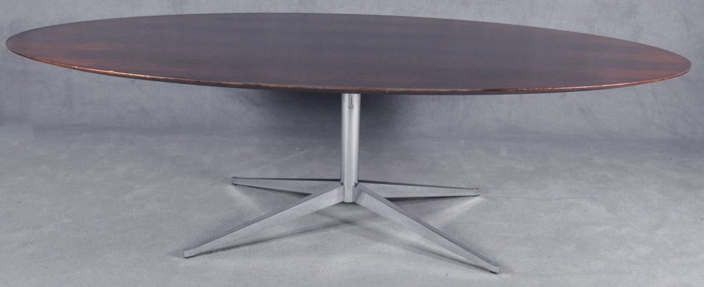 Knoll Oval Rosewood Conference Table: On polished chrome pedestal base. With fitted glass top. With nicks/wear to upper edge. With label. 28" x 96" x 54".
