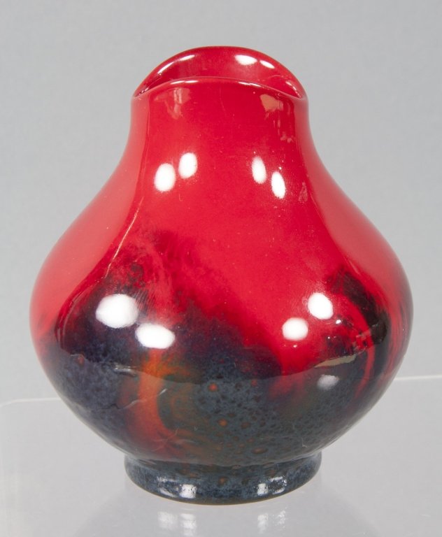 Royal Doulton Flambe Veined Vase: Having piegon-blood red on upper half of body which fades into a dark blue and grey mottled glaze at base. Marked on base, "Made in England/Royal Doulton" around lion and crown mark. Also reads "Flamb