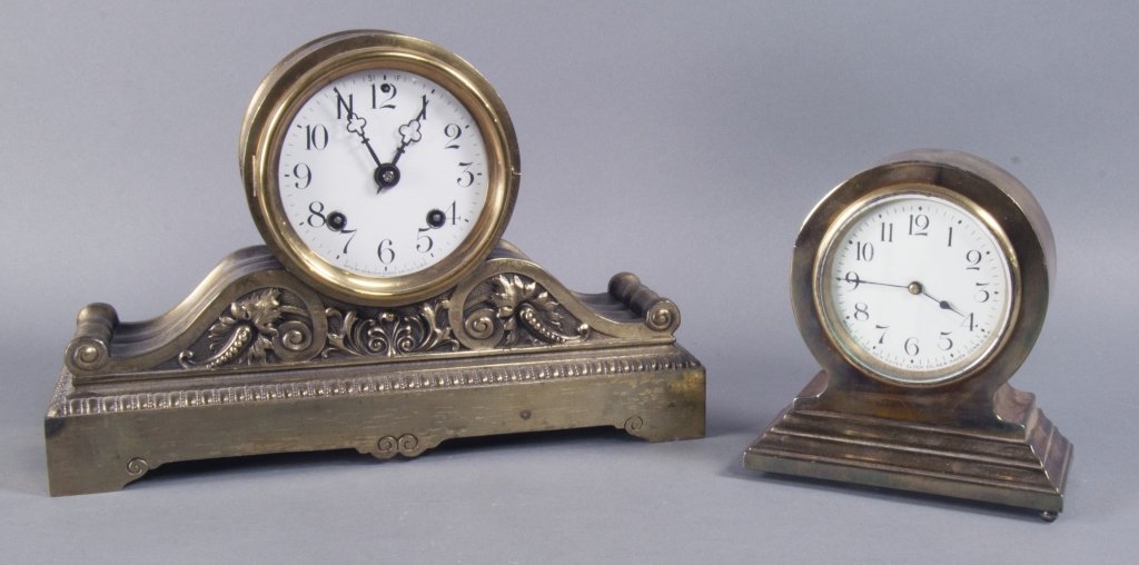 Ansonia "Hump Back" Mantel Clock: With brass finish and porcelain dial. 8 1/2" H. x 13" W. Along with New Haven Clock Co. brass case clock with porcelain dial. 6 1/2" H. x 6" W. Running condition not guaranteed.