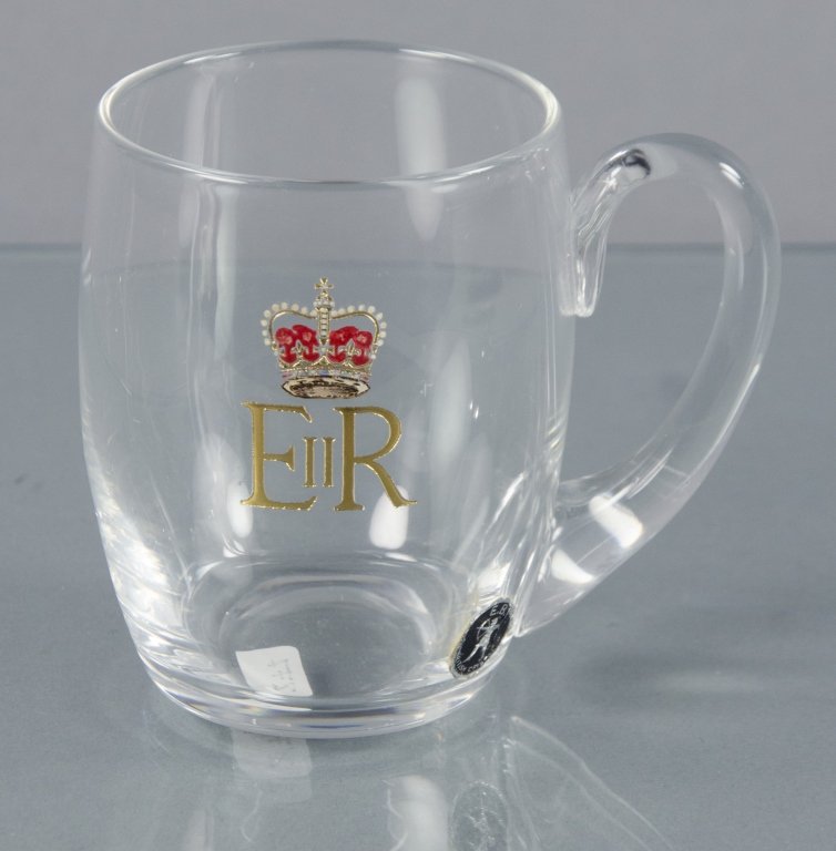 Queen Elizabeth II Commemorative Crystal Cup: By Edward Bowman & Son Ltd. Manufacturer's foil archer label affixed to surface and marked "E.B." on the underside. Decorated with a red and gold crown above the designation "EIIR." With applied handl
