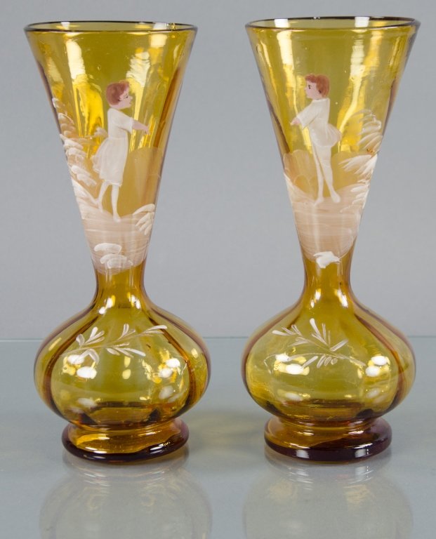 Pair of Amber Mary Gregory Trumpet Vases: Enamel decoration on one of boy and the other of girl. Both with inverted ribbed body. Tapered stem. Each 9" H.