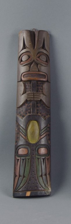 Northwest Coast American Indian Totem: Circa 1920's. Wood is red cedar, quite oxidized. Older screw eye at top for hanging. 1/4" x 1" chip at bottom. 17 1/2" H. x 3 7/8" W. at base, 3 1/4" W. at top, 1" thick.
