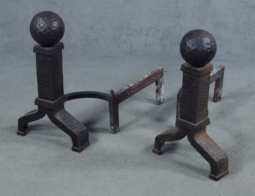 Pair of Arts & Crafts Style Andirons: Mid 20th century. Iron. Having peened decoration with ball finials above square plinths. 20" x 11".