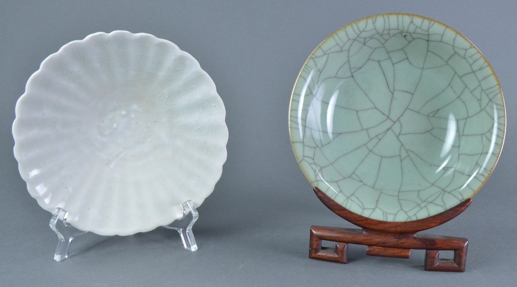 Two Chinese Bowls: One with celadon crackle glaze, 1 7/8" H. x 6 1/8" Dia. On wooden stand. The other is white with greenish glaze, 1 3/4" H. x 6" Dia. Both in Good condition.